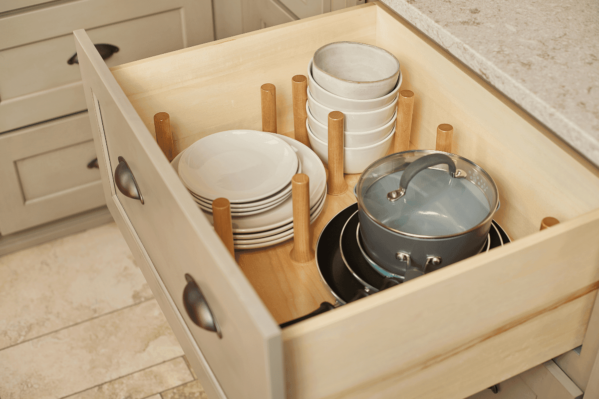 An open kitchen drawer with built-in dish organizers.