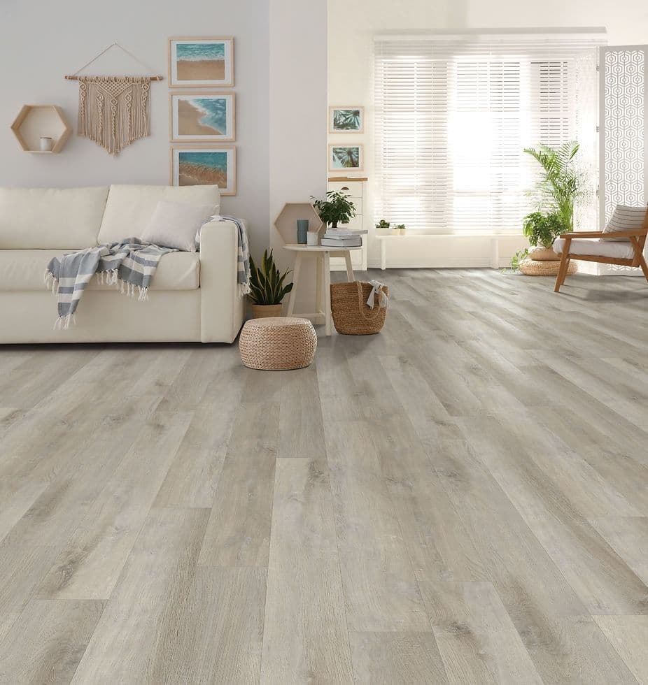 A living room area with light-colored vinyl plank flooring.